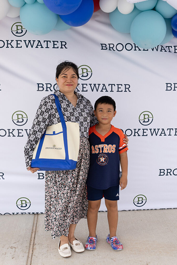 A woman and a boy stand together at a Brookewater event near Richmond TX.