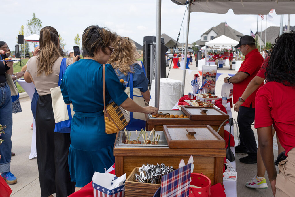 People enjoy a buffet at an outdoor event in Brookewater, a master-planned community near Richmond TX.