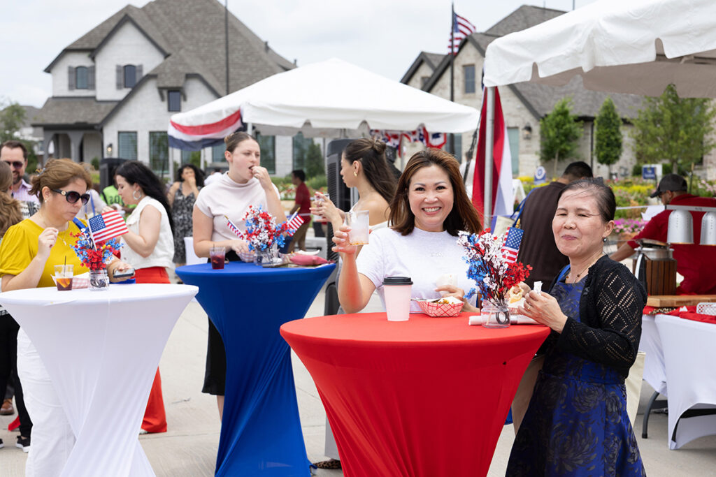 People gather at decorated tables in Brookewater, a master-planned community near Richmond TX.