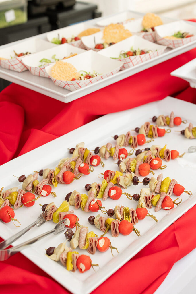 Assorted antipasto skewers and sliders displayed on trays at Brookewater’s new homes for sale.