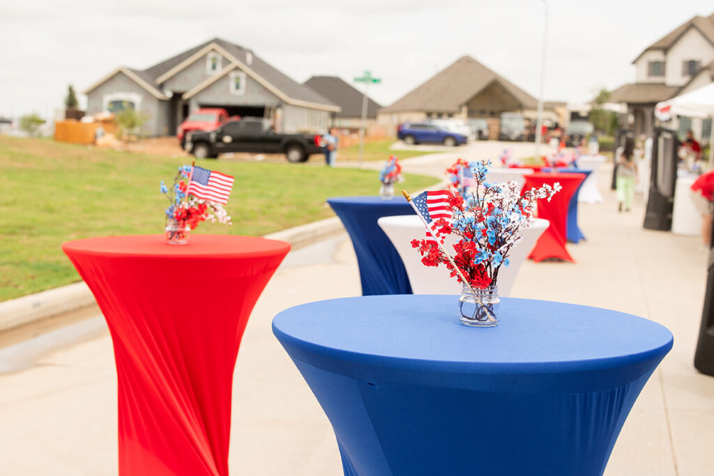 Outdoor event tables with patriotic decor in the Brookewater master-planned community.
