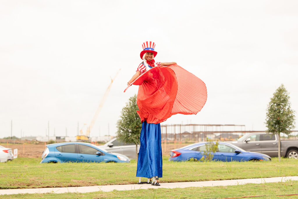 Person on stilts in red and blue costume near Brookewater close to Richmond TX.