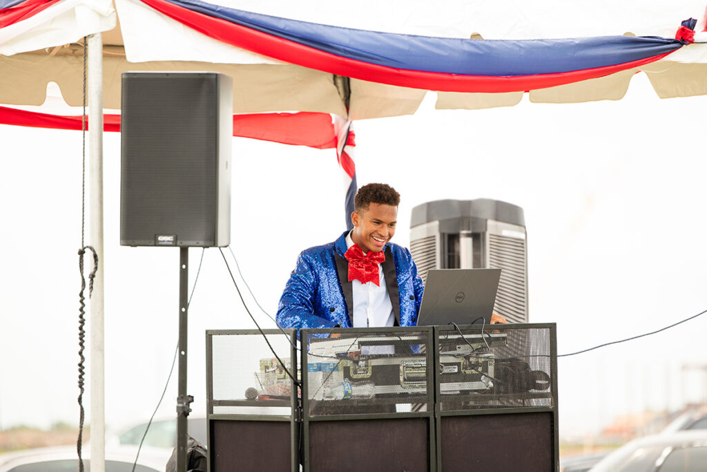 A DJ in a blue suit jacket performs at a Brookewater event near Richmond TX.