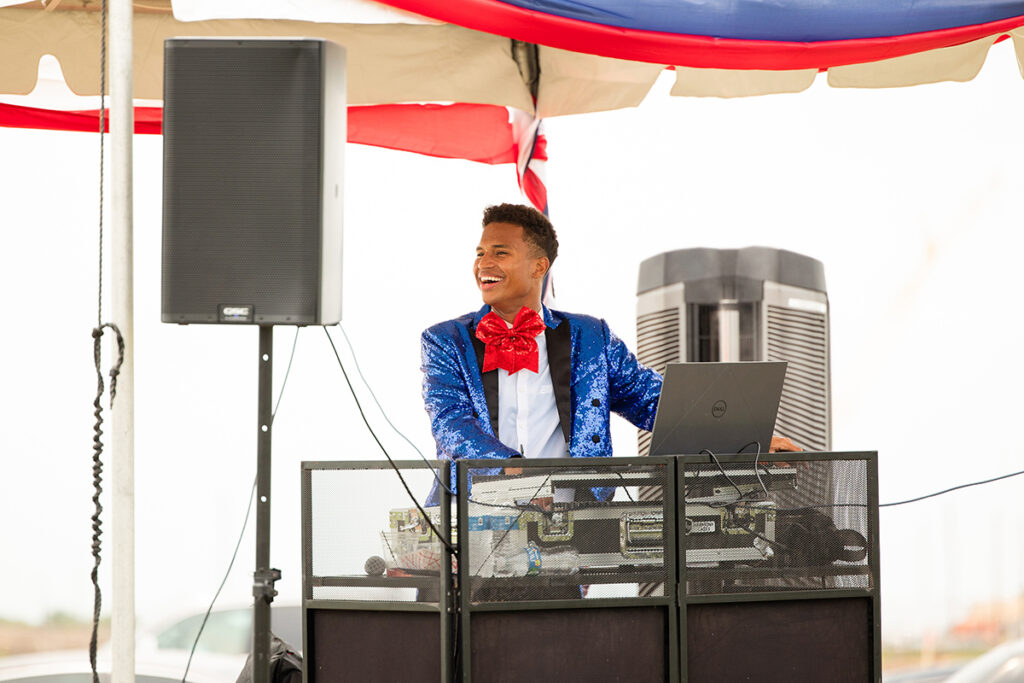 A DJ in a blue sequin jacket performs outdoors near Richmond TX, in a master-planned community Brookewater event.