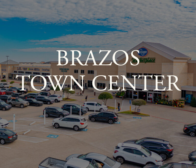 Parking lot in front of shops and Kroger Marketplace near Richmond TX at Brazos Town Center.