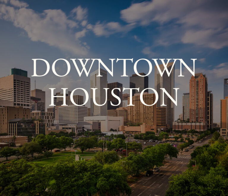 Downtown Houston skyline with tall buildings and trees near a master-planned community.