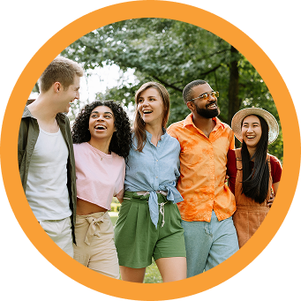Five people smile together in a park near Richmond TX, enjoying life at Brookewater.