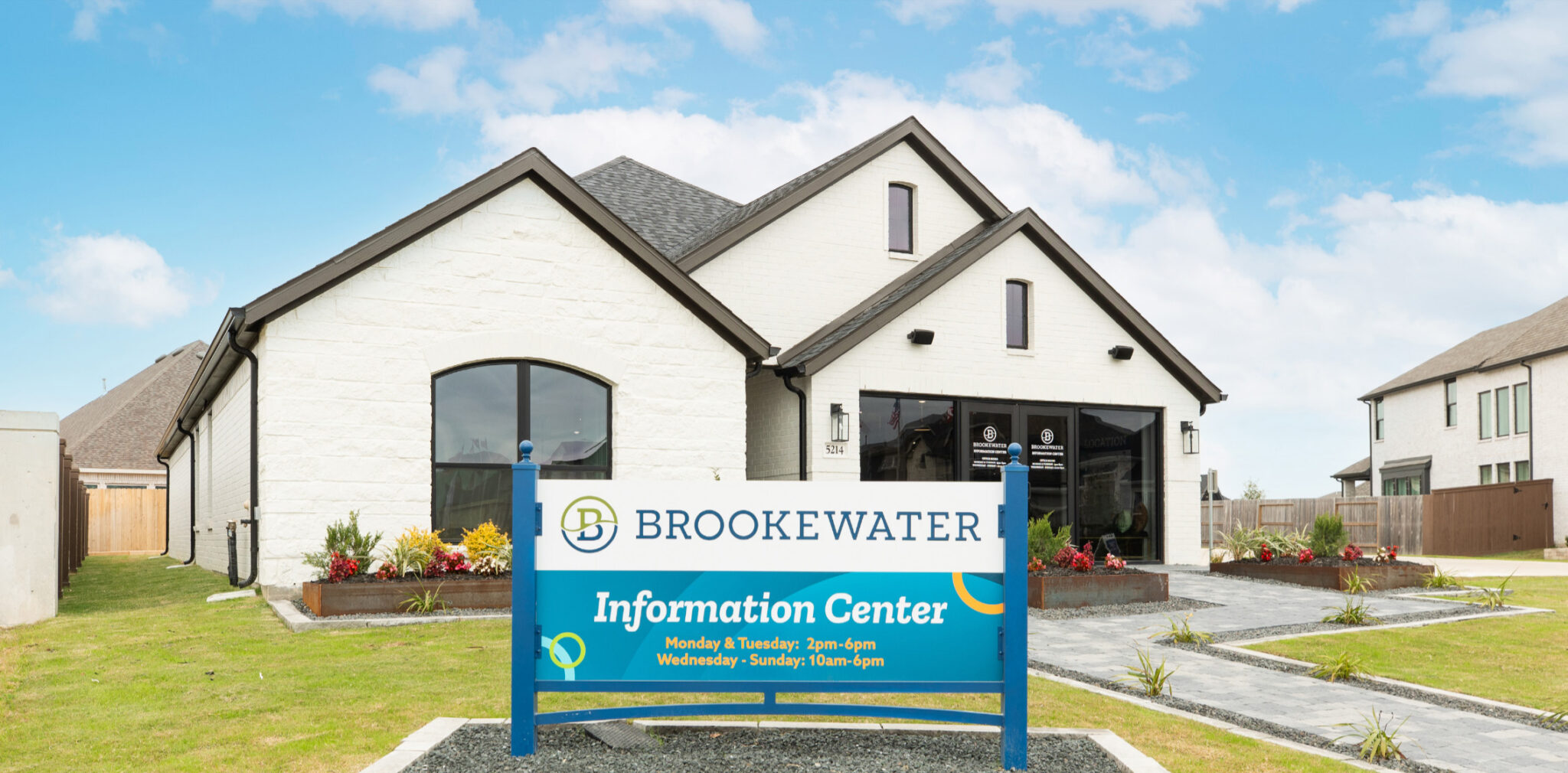 White building with a sign reading BrookeWater Information Center in front.