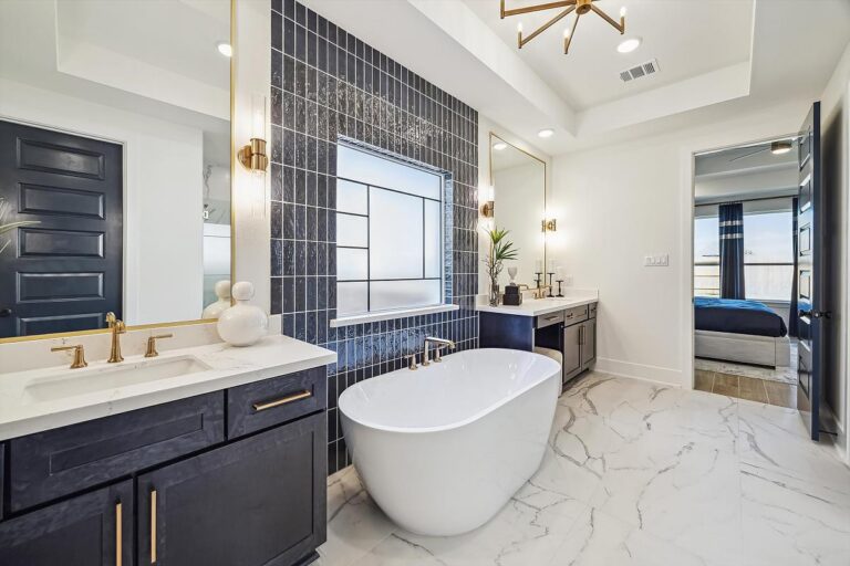 Modern bathroom with a freestanding tub, double vanity, and marble flooring.